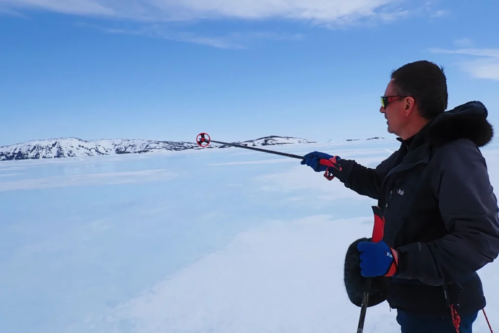 Nordic Ski Touring in East Greenland close to Kulusuk East Greenland. Einar, the guide, pointing the way forward to the next campsite.