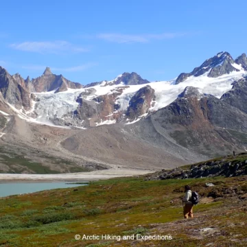 Hikers view a serene lake on the Icefjord trek, East Greenland