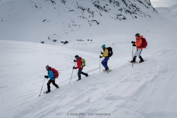 Snowshoeing in the backcountry near Sermilik ice fjord in East Greenland