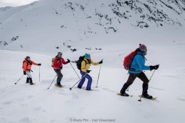 Snowshoeing in the backcountry near Sermilik ice fjord in East Greenland